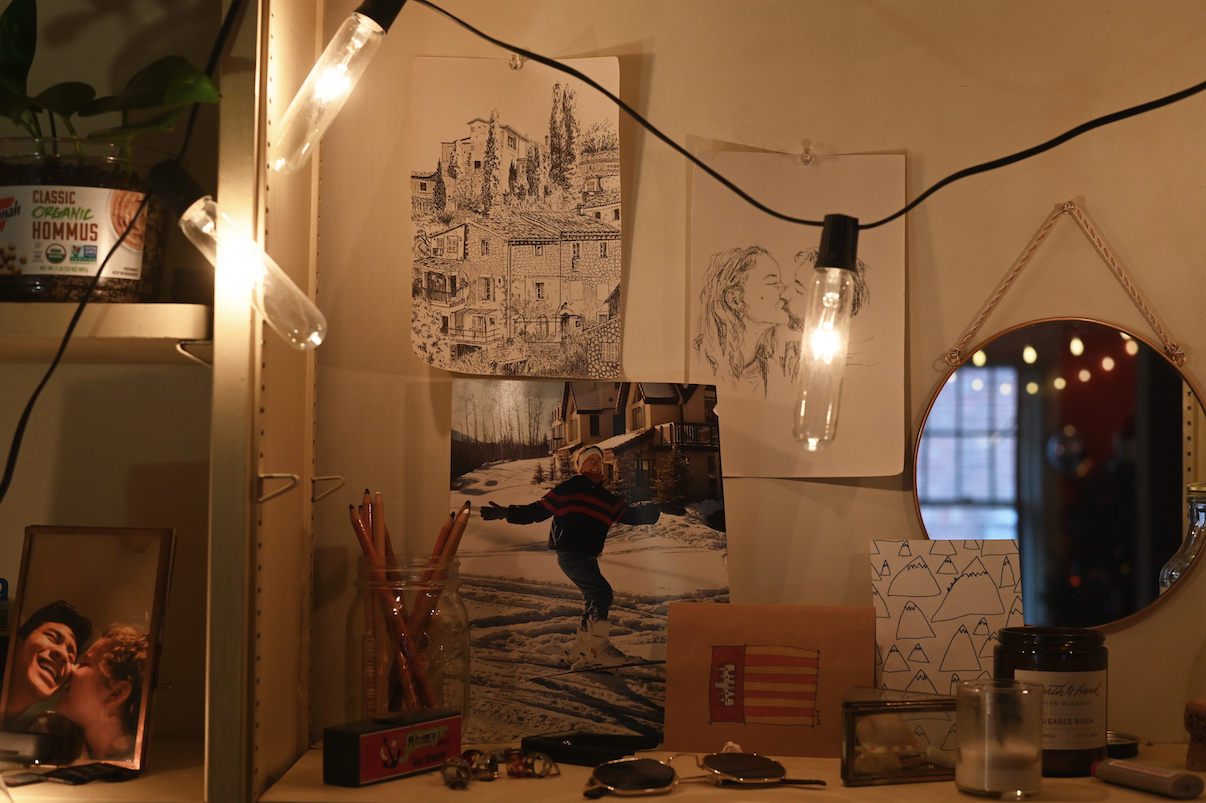 Pandemic Photo Essay: A desk decorated with lights, drawings, pictures and trinkets